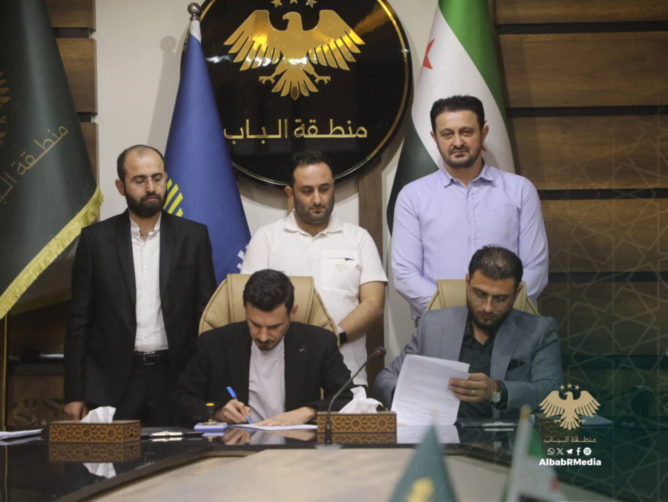 Signing the contract with representatives of both parties at the Al-Bab district administration building